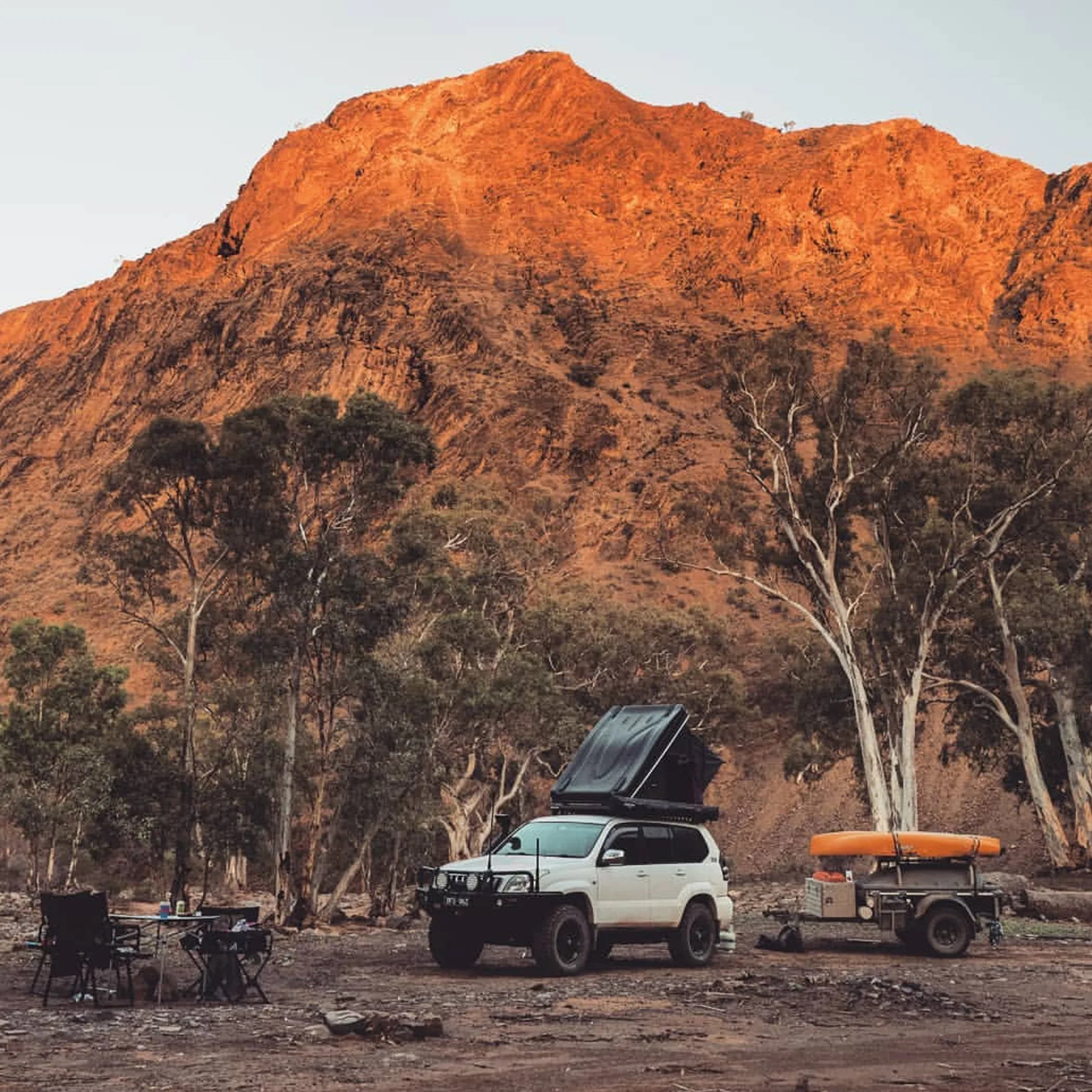 campsite beneath rugged orange ranges